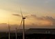 Windmill farm on mountain with sunset sky