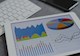 Four colorful graphs displayed on a tablet