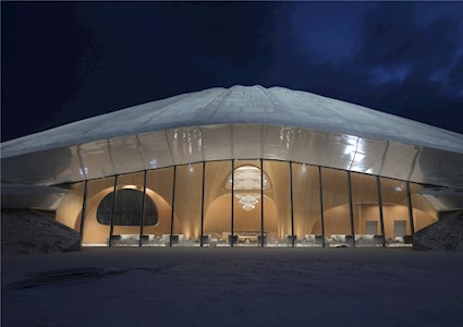 Large free-form structure showing the lobby filled with chairs and tables. 