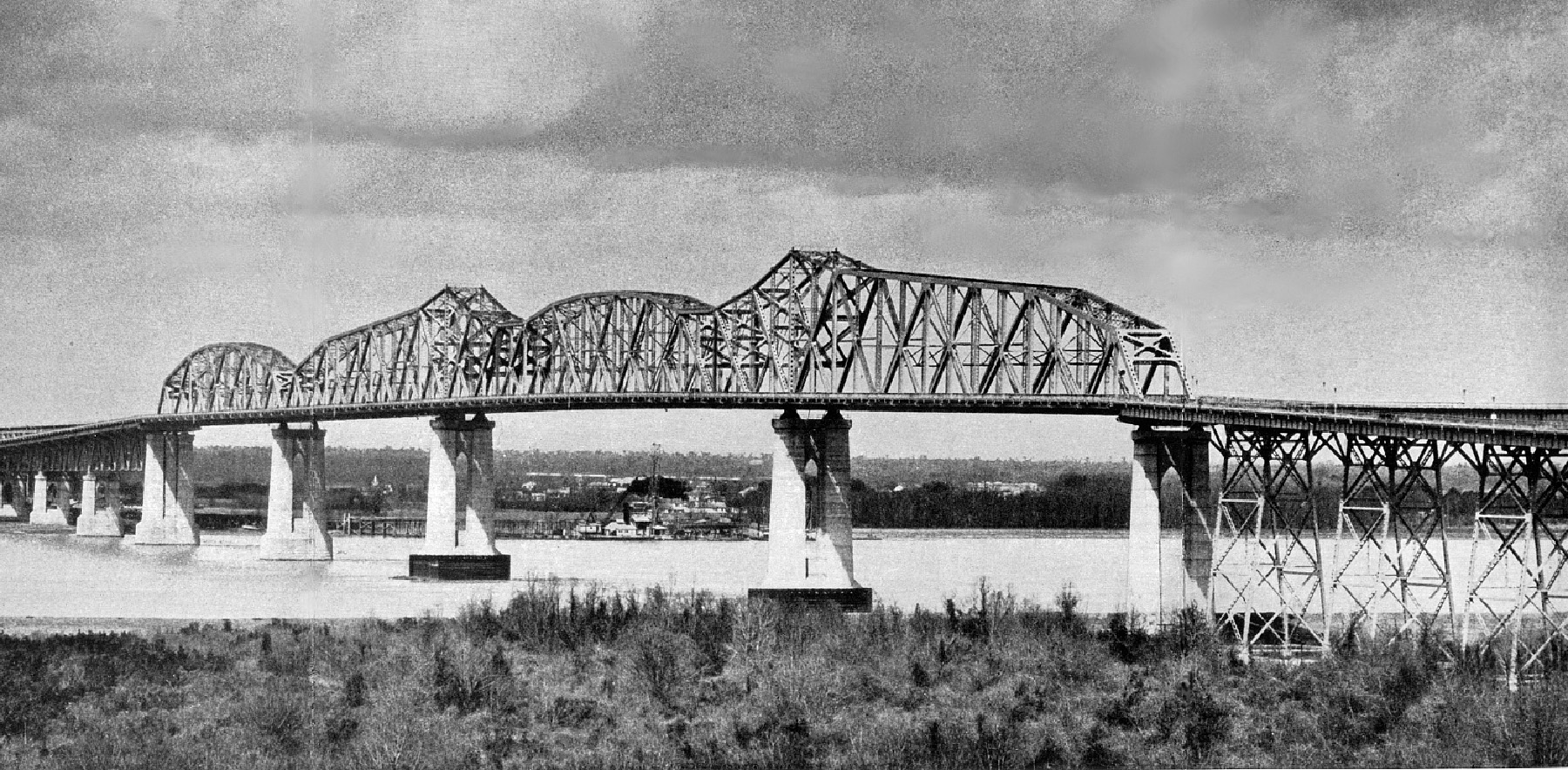 Photo shows the completed Huey P. Long Bridge, which spans the Mississippi River.