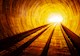 A rail tunnel is brightly lit. 