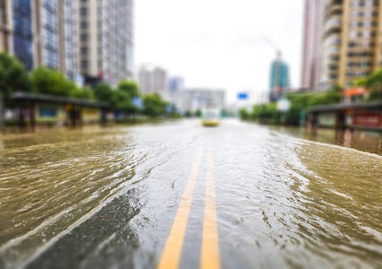 Photograph shows a flooded street.