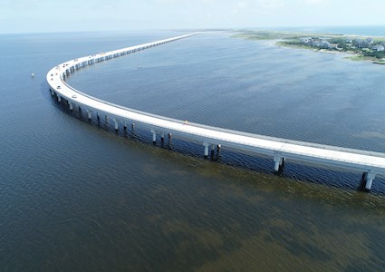 Uniquely shaped bridge curves over a large body of water.