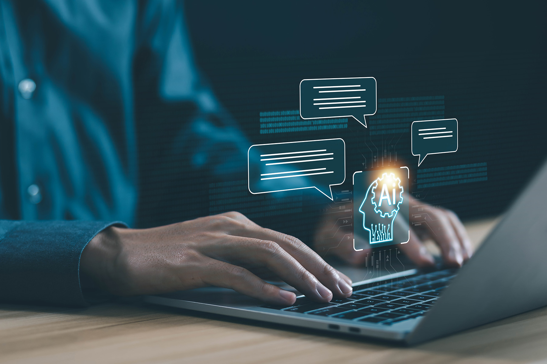 A pair of hands work on the keys of a laptop projecting images of text and a human head marked AI.