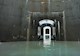 Photo shows an underground water storage facility comprised of six interconnected concrete cells. In the photo the cells are partially flooded. 