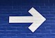 white arrow pointing right on blue background