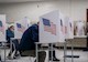 voters sit in booths casing ballots