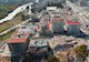 Image shows the aftermath of an earthquake with collapsed and partially collapsed structures. 