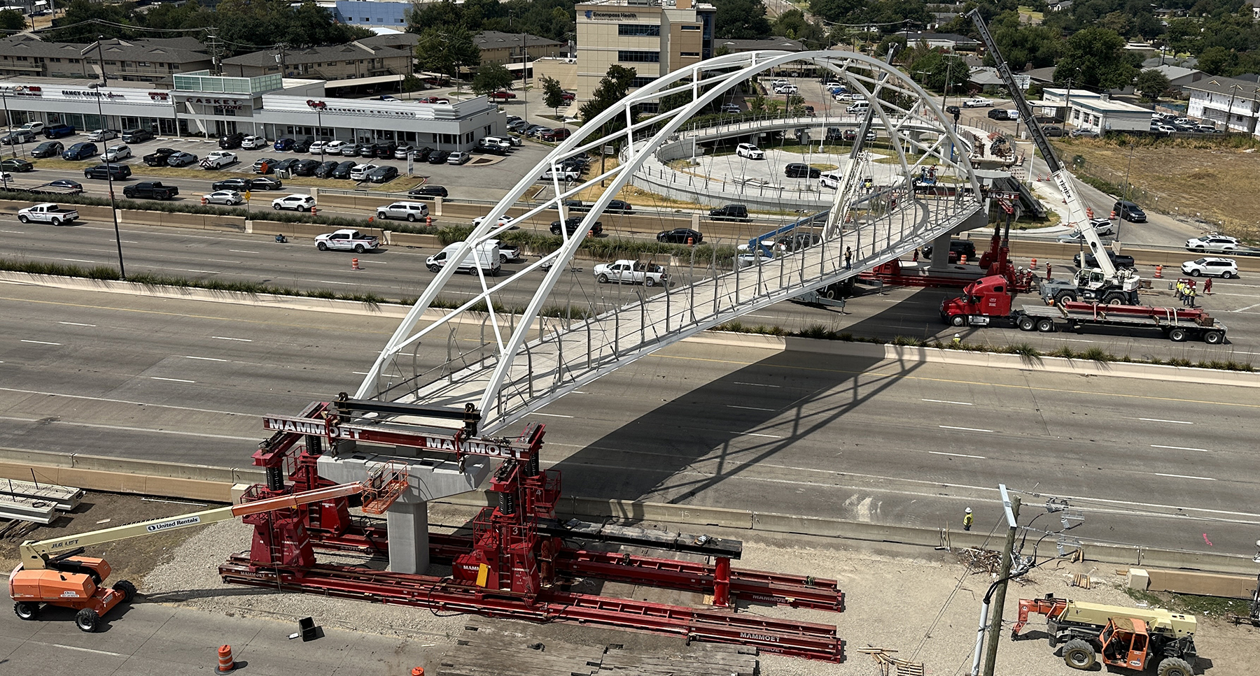 a pedestrian bridge spans a highway a pedestrian bridge spans a highway