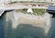 aerial overview of a rocky shoreline near a road